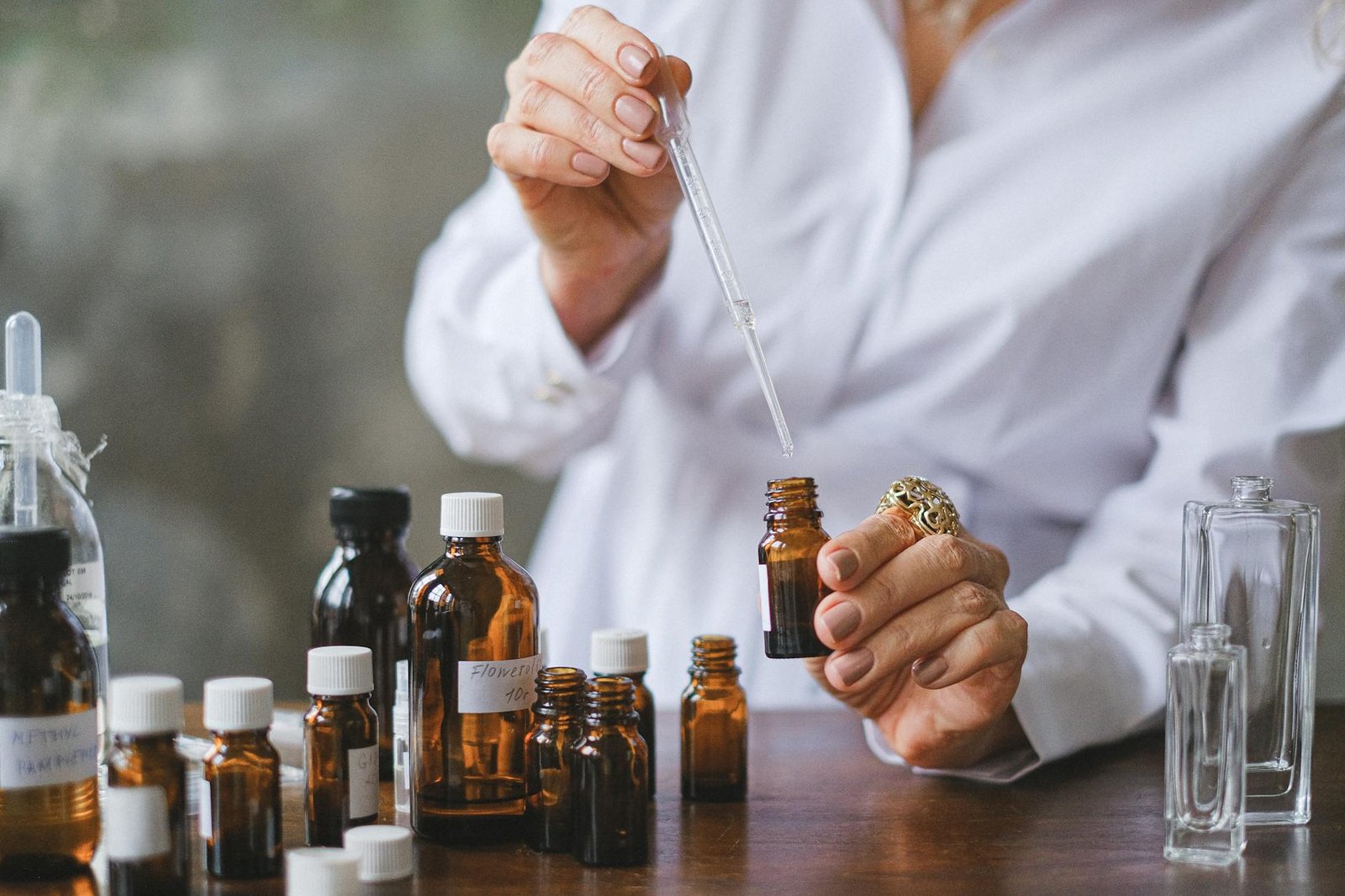 selective focus photo of dropper and amber bottles